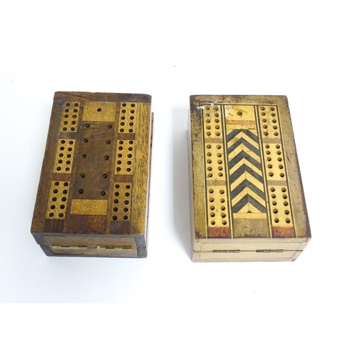 865 - Toys: Two early 20thC travelling / folding cribbage boards with inlaid detail. Together with a pack ... 