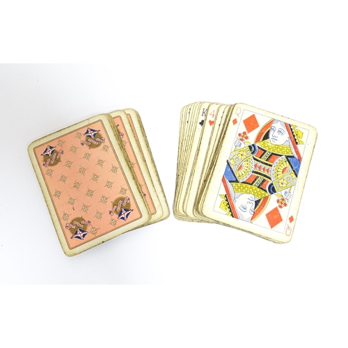 865 - Toys: Two early 20thC travelling / folding cribbage boards with inlaid detail. Together with a pack ... 