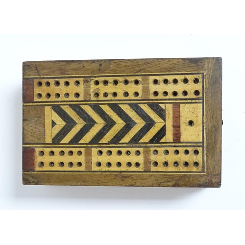 865 - Toys: Two early 20thC travelling / folding cribbage boards with inlaid detail. Together with a pack ... 