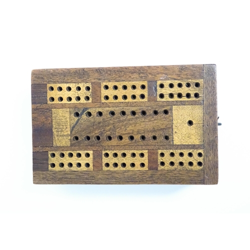 865 - Toys: Two early 20thC travelling / folding cribbage boards with inlaid detail. Together with a pack ... 