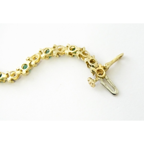 672 - A 9ct gold tennis bracelet set with diamonds and emeralds. Approx. 8