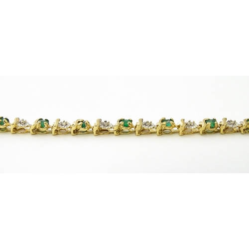 672 - A 9ct gold tennis bracelet set with diamonds and emeralds. Approx. 8