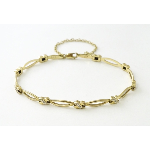 673 - A 9ct gold bracelet set with diamonds. Approx 7 1/2