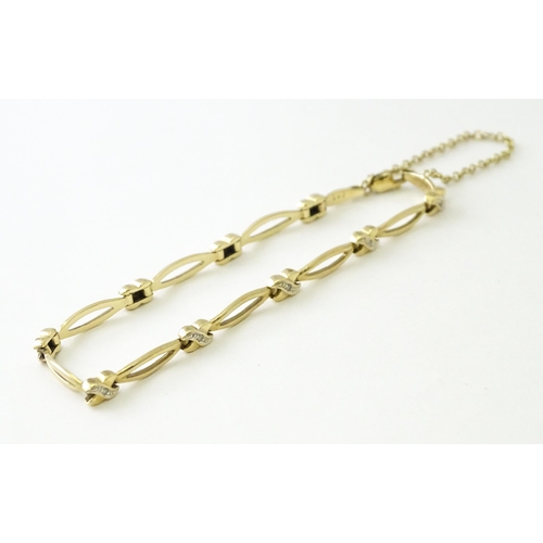 673 - A 9ct gold bracelet set with diamonds. Approx 7 1/2