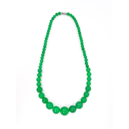 683 - A graduated bead necklace of jade green coloured beads. Approx. 18