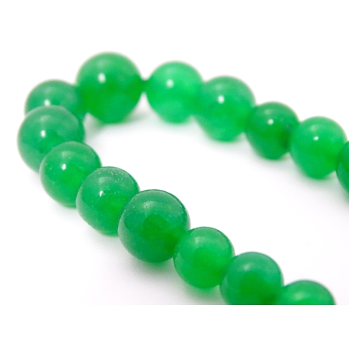 683 - A graduated bead necklace of jade green coloured beads. Approx. 18