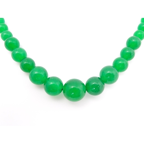 683 - A graduated bead necklace of jade green coloured beads. Approx. 18