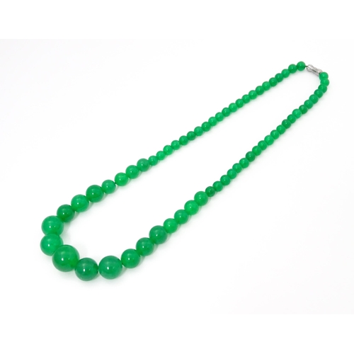 683 - A graduated bead necklace of jade green coloured beads. Approx. 18