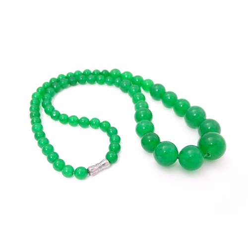 683 - A graduated bead necklace of jade green coloured beads. Approx. 18