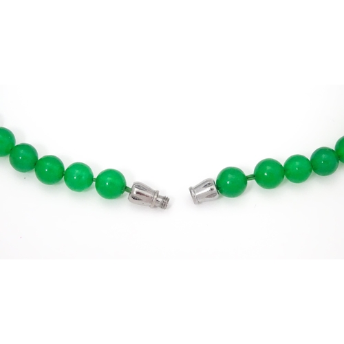 683 - A graduated bead necklace of jade green coloured beads. Approx. 18