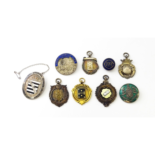 726 - Assorted fobs, badges etc to include: Three hallmarked silver fobs relating to the game of dominoes ... 