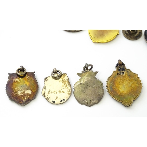 726 - Assorted fobs, badges etc to include: Three hallmarked silver fobs relating to the game of dominoes ... 