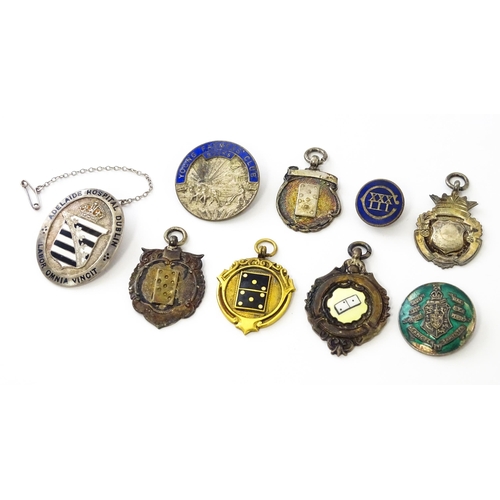 726 - Assorted fobs, badges etc to include: Three hallmarked silver fobs relating to the game of dominoes ... 