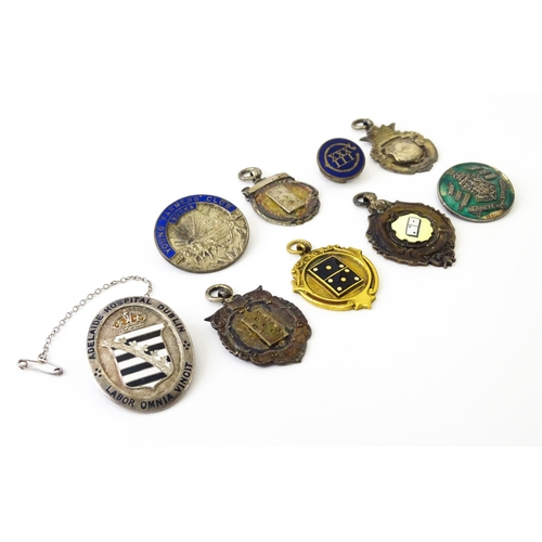 726 - Assorted fobs, badges etc to include: Three hallmarked silver fobs relating to the game of dominoes ... 