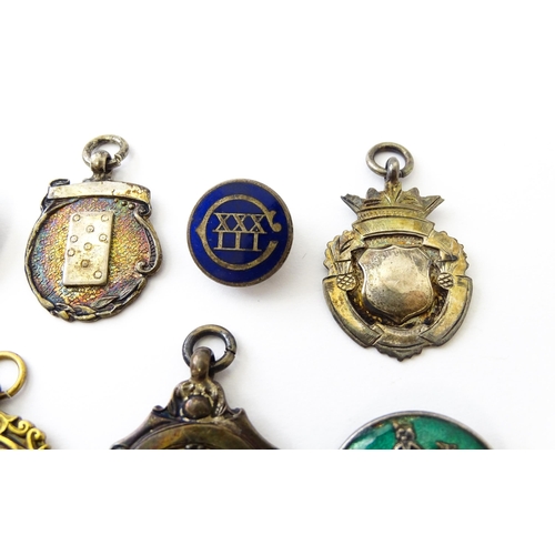 726 - Assorted fobs, badges etc to include: Three hallmarked silver fobs relating to the game of dominoes ... 