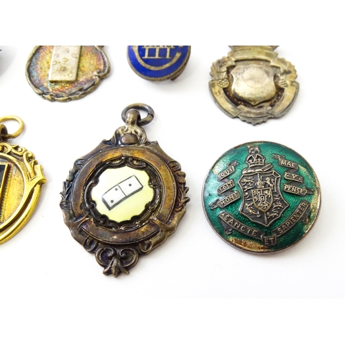 726 - Assorted fobs, badges etc to include: Three hallmarked silver fobs relating to the game of dominoes ... 