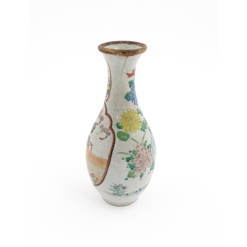 11 - An Oriental vase with crackle glaze decorated with flowers, foliage and a female figure. Approx. 12