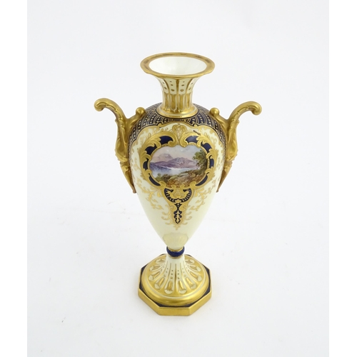 109 - A Wedgwood pedestal vase with twin handles, gilt decoration and hand painted mountain landscape. Mar... 