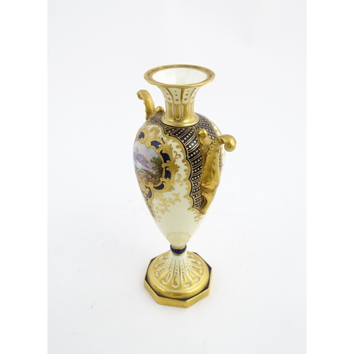 109 - A Wedgwood pedestal vase with twin handles, gilt decoration and hand painted mountain landscape. Mar... 