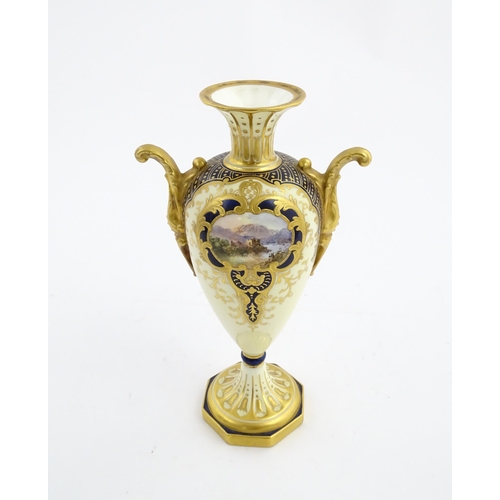 109 - A Wedgwood pedestal vase with twin handles, gilt decoration and hand painted mountain landscape. Mar... 