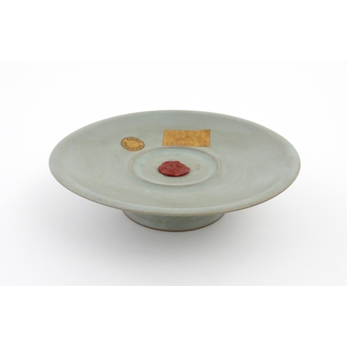 14 - A Chinese celadon footed bowl, bearing wax seal and paper labels. Approx. 7