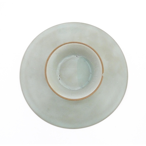 14 - A Chinese celadon footed bowl, bearing wax seal and paper labels. Approx. 7