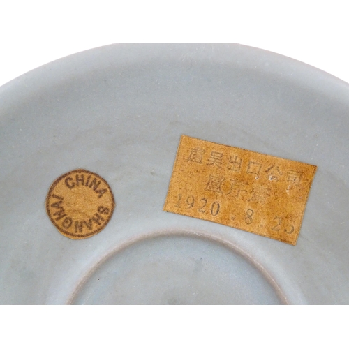 14 - A Chinese celadon footed bowl, bearing wax seal and paper labels. Approx. 7