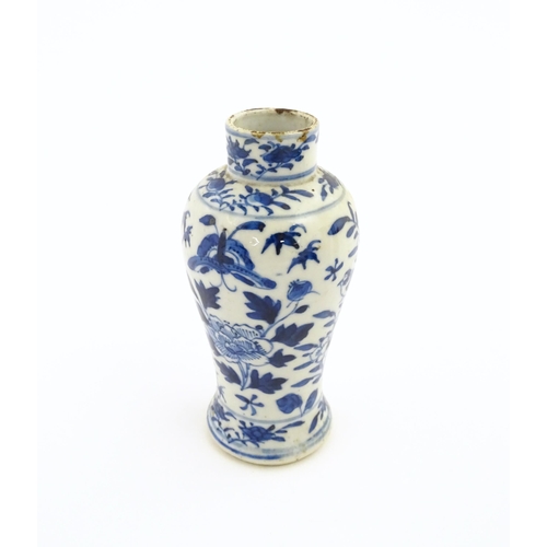 15 - A Chinese blue and white vase decorated with flowers, foliage, birds and insects. Approx. 5 1/4