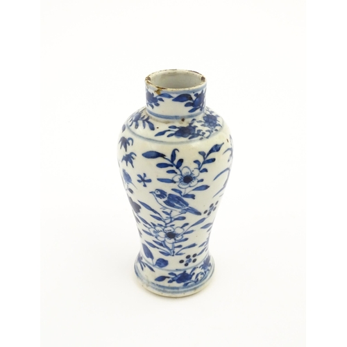 15 - A Chinese blue and white vase decorated with flowers, foliage, birds and insects. Approx. 5 1/4