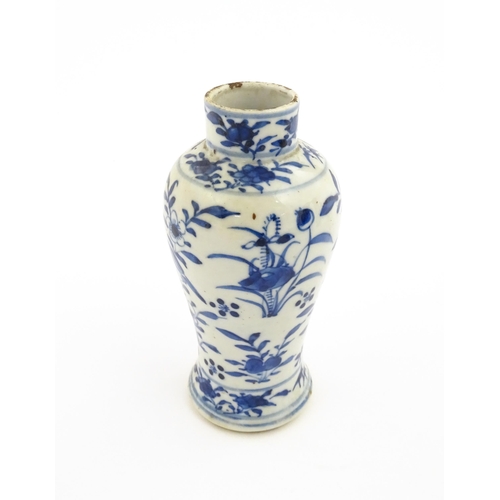 15 - A Chinese blue and white vase decorated with flowers, foliage, birds and insects. Approx. 5 1/4