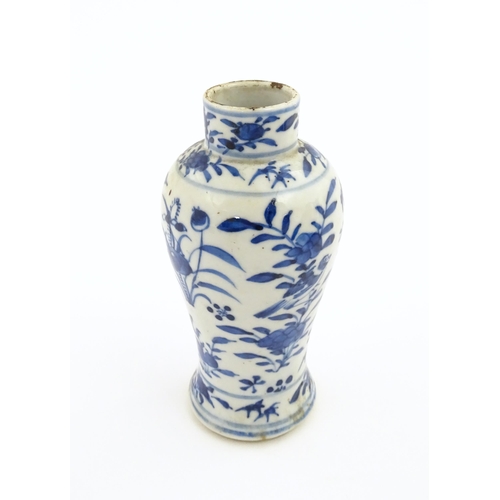 15 - A Chinese blue and white vase decorated with flowers, foliage, birds and insects. Approx. 5 1/4