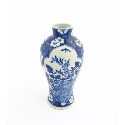 3 - A Chinese blue and white vase decorated with birds, flowers, and prunus blossom. Character marks und... 