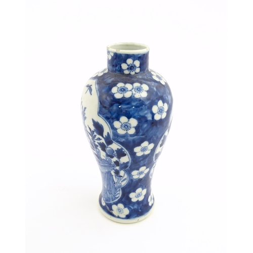 3 - A Chinese blue and white vase decorated with birds, flowers, and prunus blossom. Character marks und... 