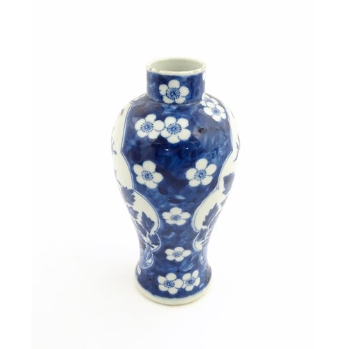 3 - A Chinese blue and white vase decorated with birds, flowers, and prunus blossom. Character marks und... 