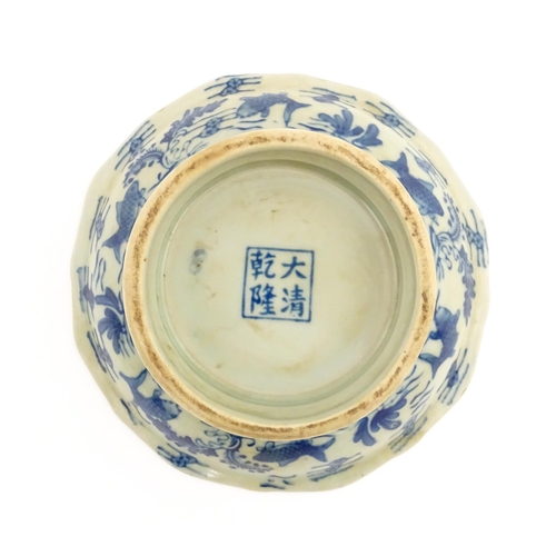 18 - A Chinese blue and white footed dish decorated with fish. Character marks under. Together with a woo... 