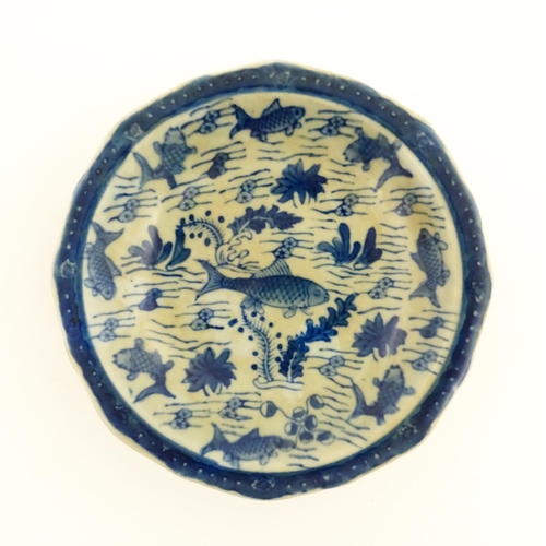 18 - A Chinese blue and white footed dish decorated with fish. Character marks under. Together with a woo... 