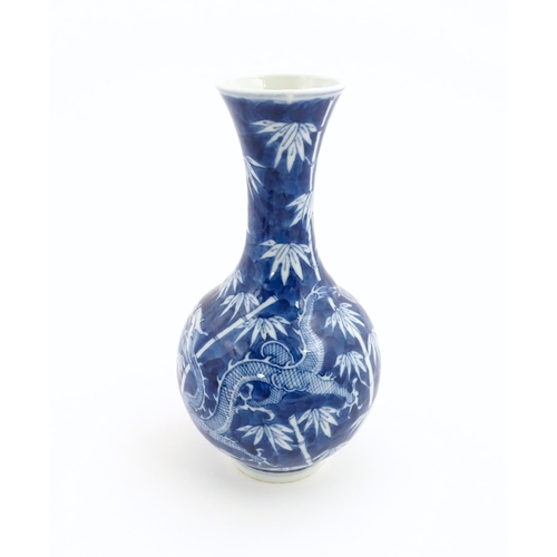 2 - A Chinese blue and white vase decorated with a dragon amongst bamboo. Ring marks under. Approx. 8 1/... 