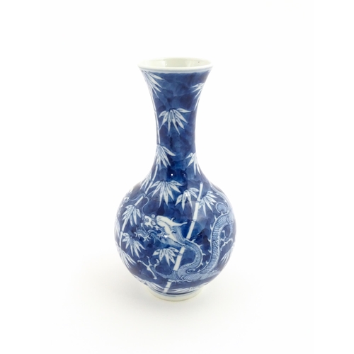 2 - A Chinese blue and white vase decorated with a dragon amongst bamboo. Ring marks under. Approx. 8 1/... 