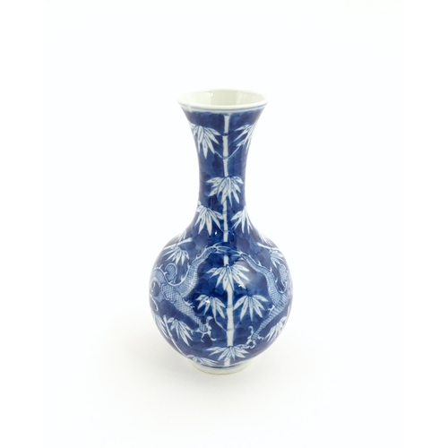 2 - A Chinese blue and white vase decorated with a dragon amongst bamboo. Ring marks under. Approx. 8 1/... 