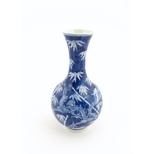 2 - A Chinese blue and white vase decorated with a dragon amongst bamboo. Ring marks under. Approx. 8 1/... 