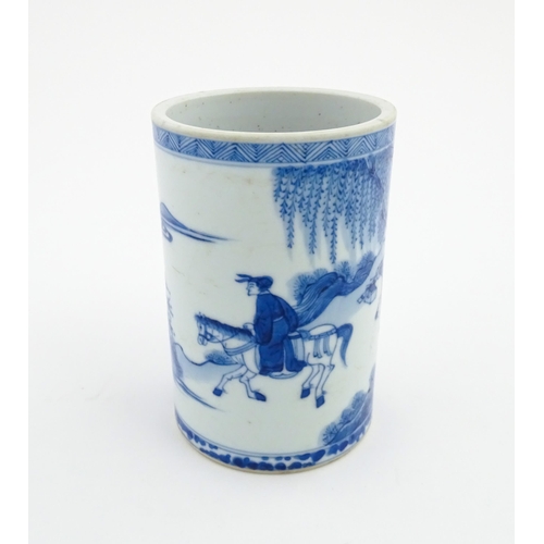 26 - A Chinese blue and white brush pot depicting a figure on horseback and an attendant in a landscape. ... 