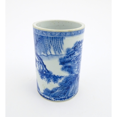 26 - A Chinese blue and white brush pot depicting a figure on horseback and an attendant in a landscape. ... 