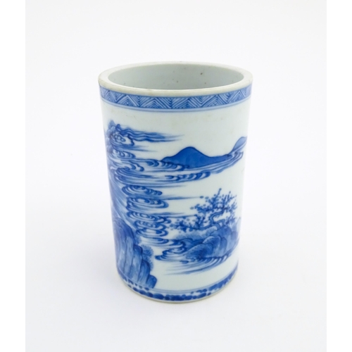 26 - A Chinese blue and white brush pot depicting a figure on horseback and an attendant in a landscape. ... 