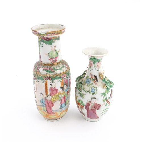 28 - Two Chinese / Cantonese famille rose vases decorated with figures, flowers and foliage, one with rel... 