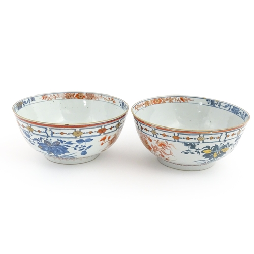 4 - A matched pair of Japanese bowls decorated in the Imari palette with flowers and foliage. Approx. 5