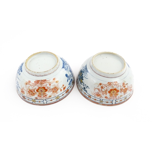 4 - A matched pair of Japanese bowls decorated in the Imari palette with flowers and foliage. Approx. 5