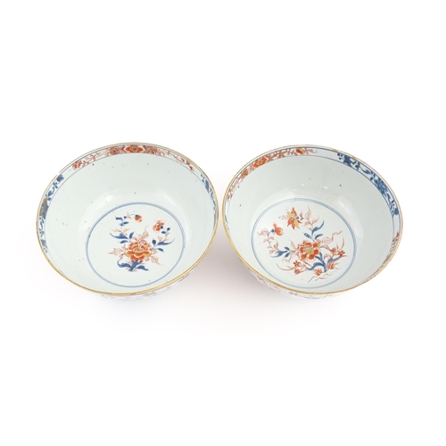 4 - A matched pair of Japanese bowls decorated in the Imari palette with flowers and foliage. Approx. 5