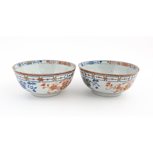 4 - A matched pair of Japanese bowls decorated in the Imari palette with flowers and foliage. Approx. 5