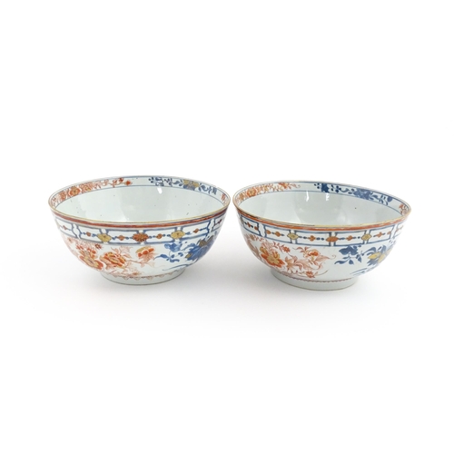 4 - A matched pair of Japanese bowls decorated in the Imari palette with flowers and foliage. Approx. 5