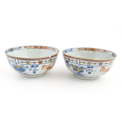 4 - A matched pair of Japanese bowls decorated in the Imari palette with flowers and foliage. Approx. 5